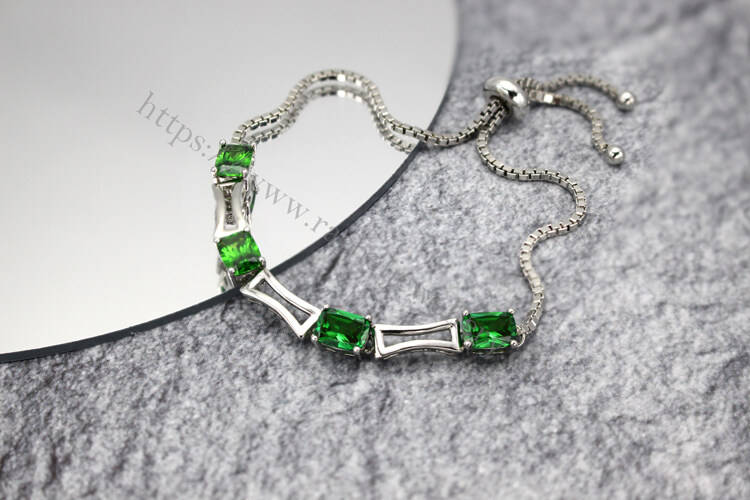 White gold and emerald bracelet manufacturers.jpg
