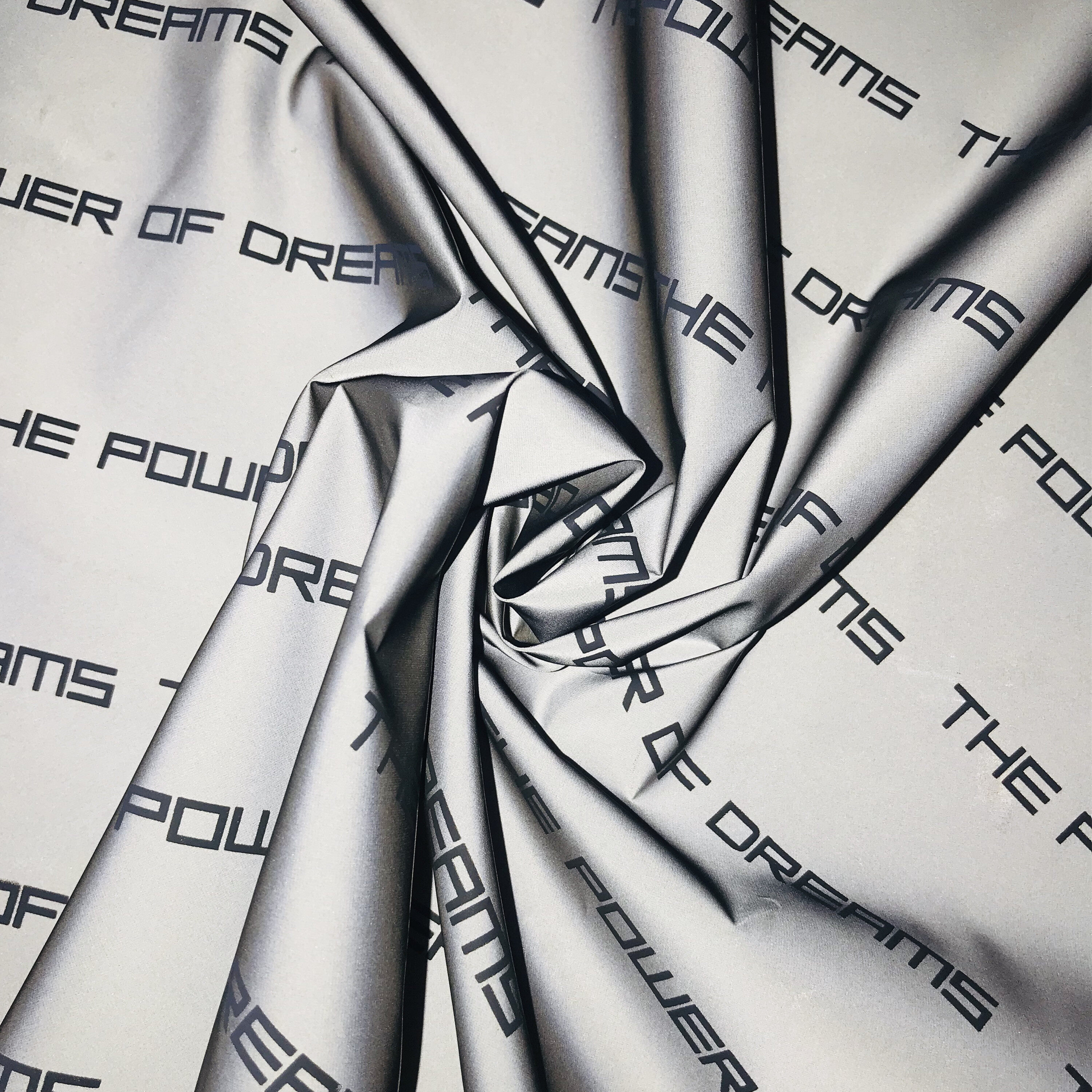 100%p reflective fabric with Letter design