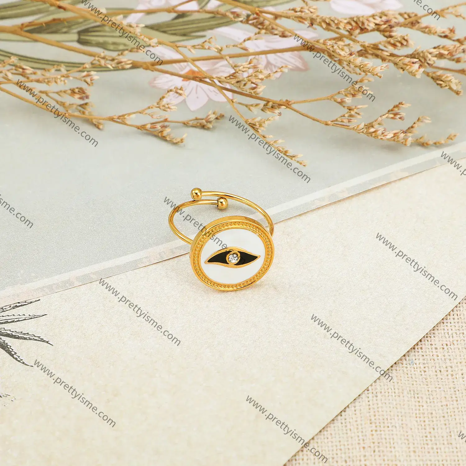 Stainless steel and 18K gold plated abstract eye motif with diamond round open ring.webp