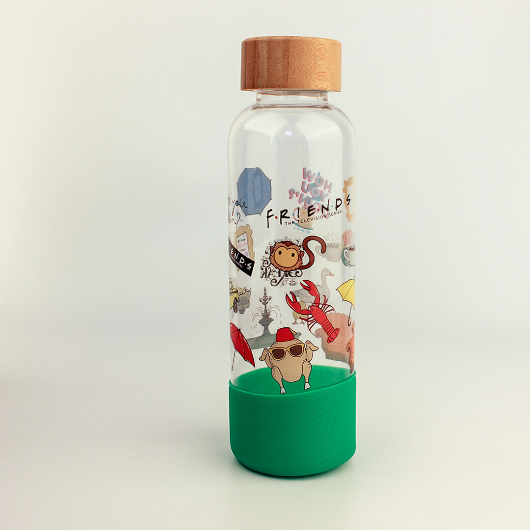 Color patterned glass water bottle with wooden top and green silicone sleeve