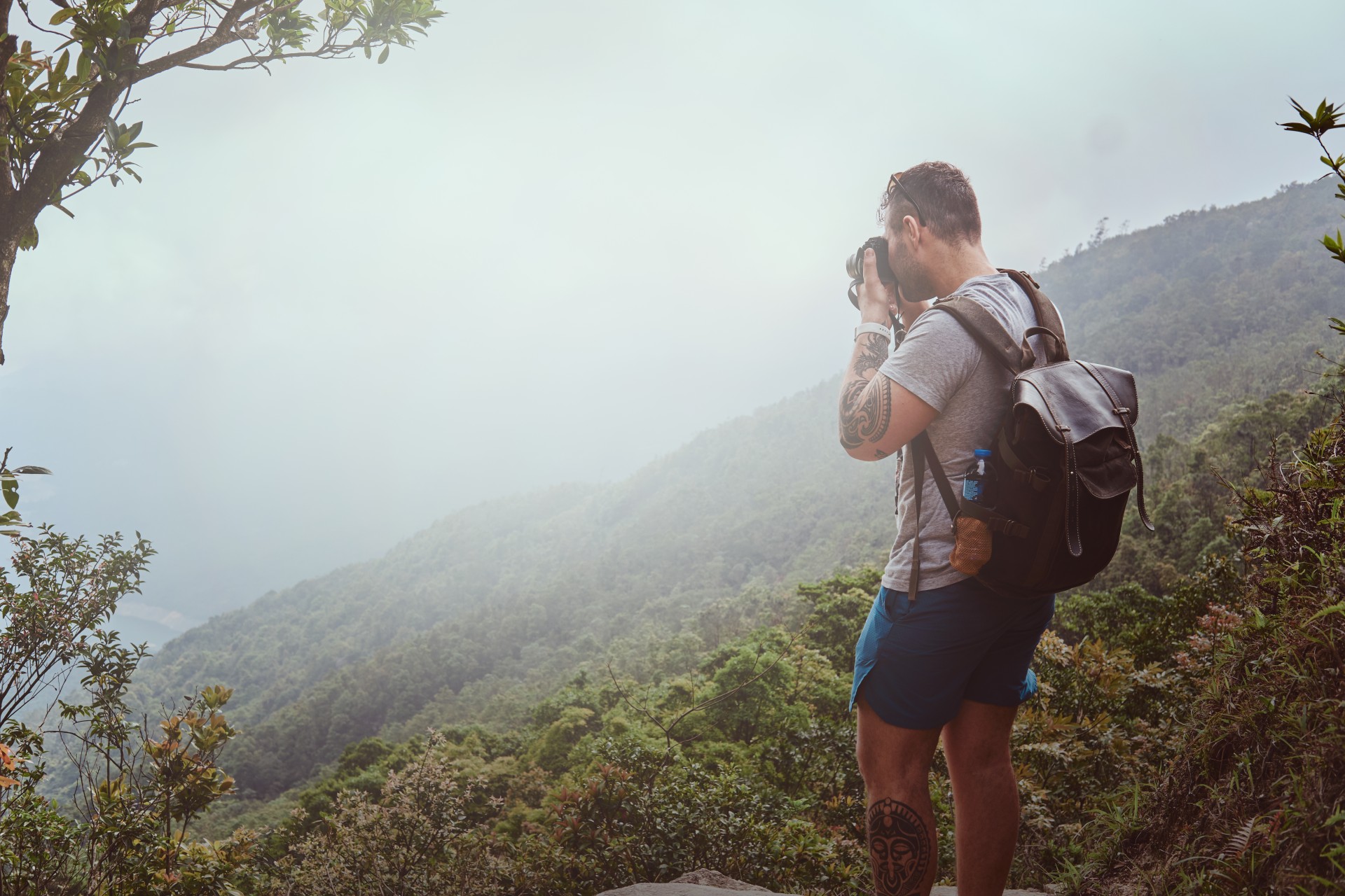 young-man-with-backpack-is-taking-photo-beautiful-nature-his-photo-camera-while-hiking-mountains.jpg