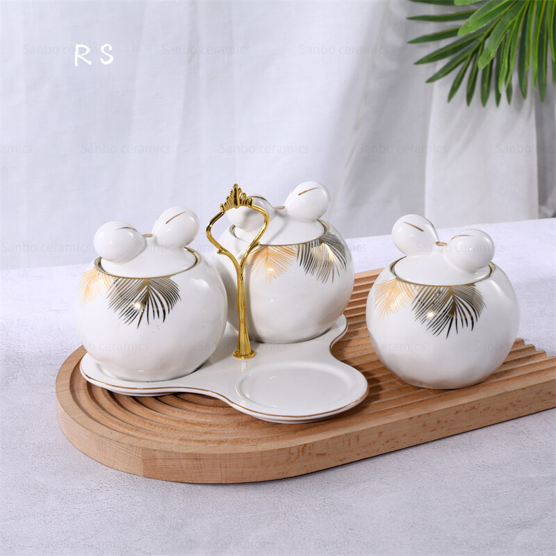 kitchen storage jars; white and gold canisters; white ceramic canisters