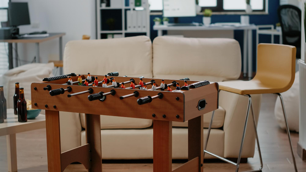 An inviting game room featuring a modern design foosball table and comfortable seating..jpg