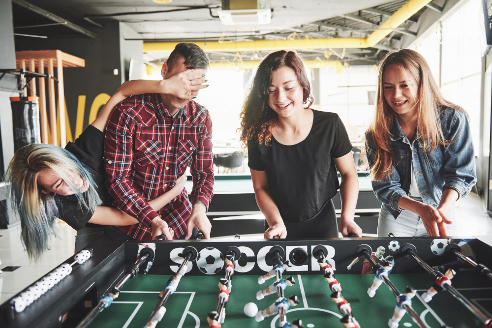 Friends enjoying a game of foosball together.jpg